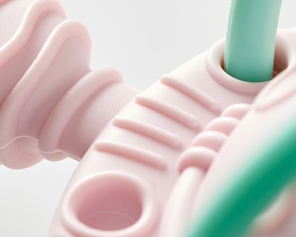 How do baby toys stimulate sensory development?